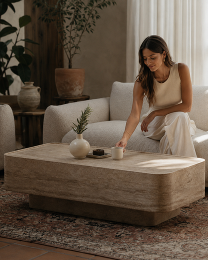 ECHO coffee table by DEKATO LIVING styled with a woman placing a cup in a relaxed contemporary interior