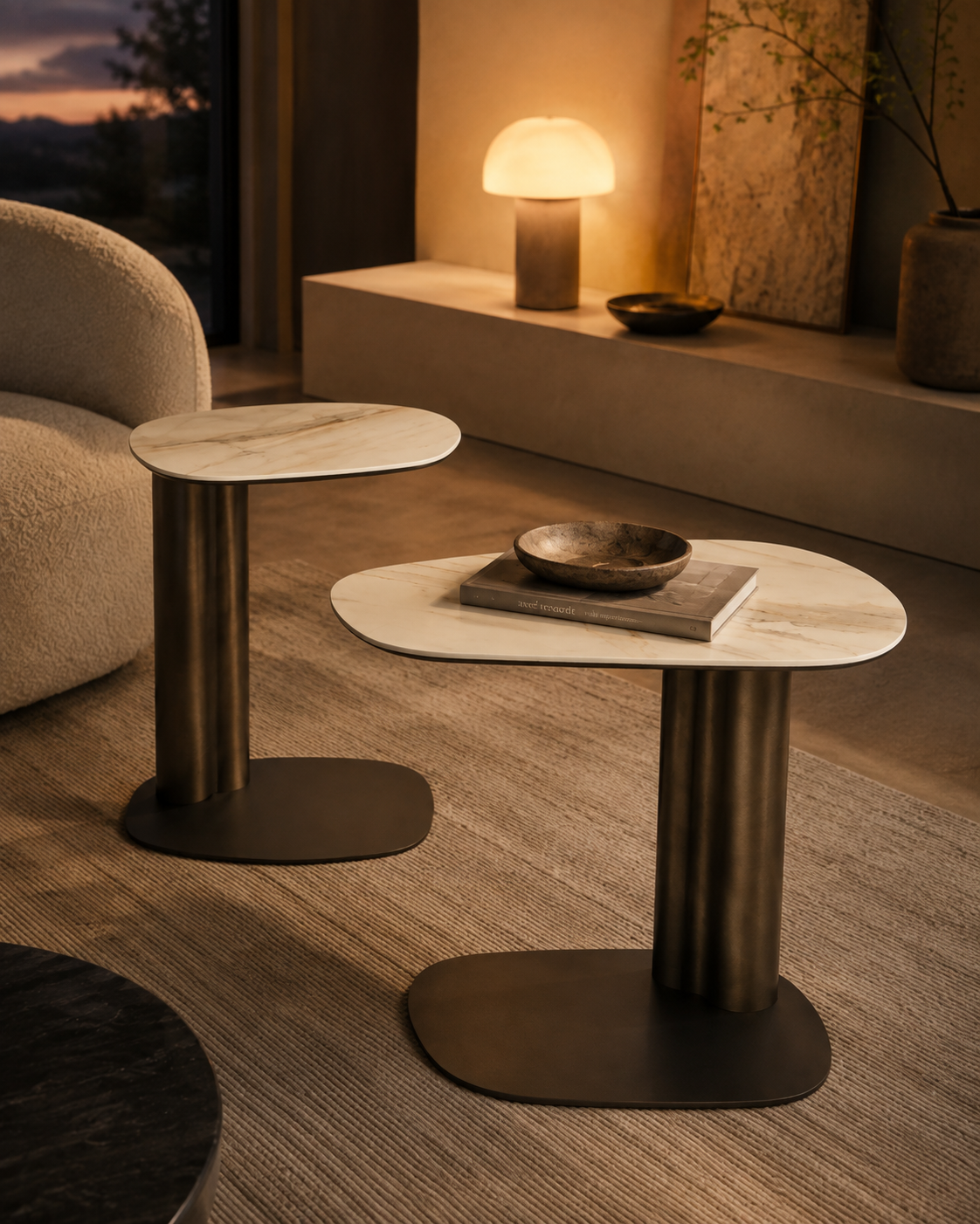 KAVO bronze pedestal and ceramic top tables by DEKATO LIVING in an evening living room setting