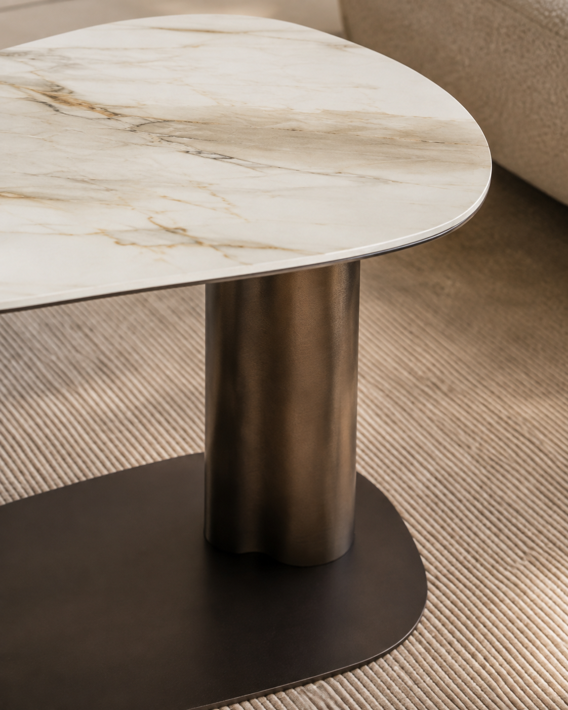 Detail view of KAVO stone-look ceramic surface and sculptural bronze pedestal by DEKATO LIVING
