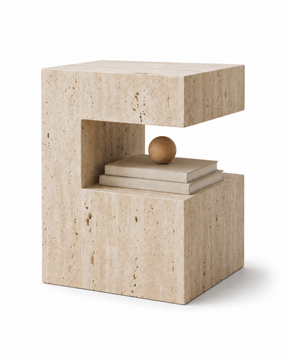 PIETRA natural travertine side table by DEKATO LIVING styled as a bedside table in a softly lit bedroom