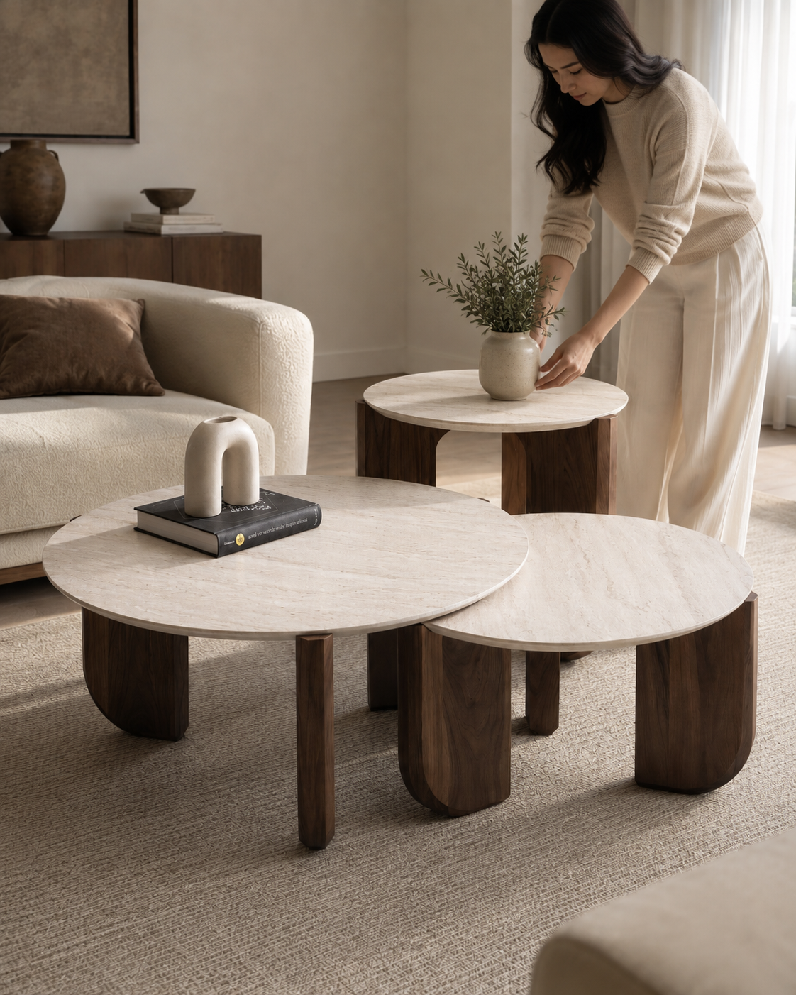 TAVO coffee table set by DEKATO LIVING styled with a woman arranging decor