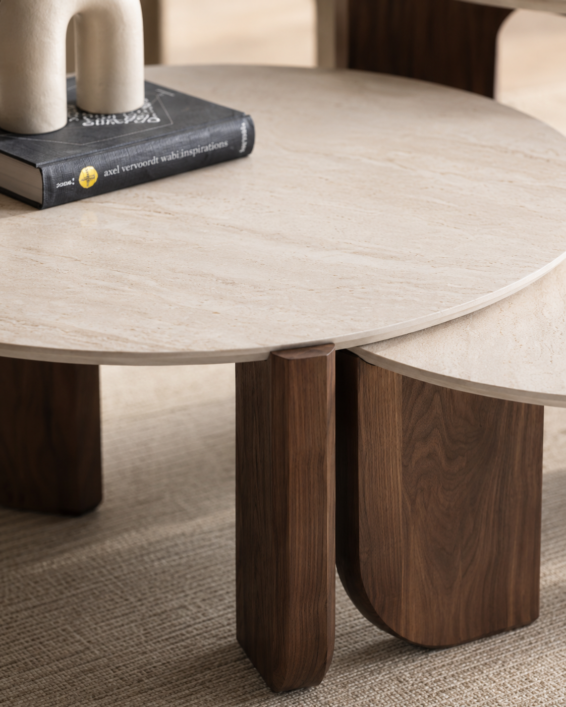 Close-up of TAVO travertine-look tabletop and walnut veneer base by DEKATO LIVING