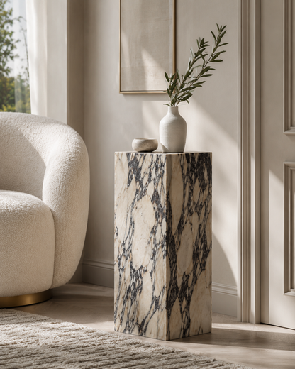 VIOLA natural Calacatta Viola marble pedestal by DEKATO LIVING styled with ceramics in a bright contemporary living space