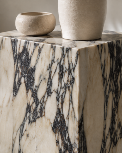 Close-up of VIOLA Calacatta Viola marble pedestal by DEKATO LIVING showing the rectangular edge and dramatic violet veining