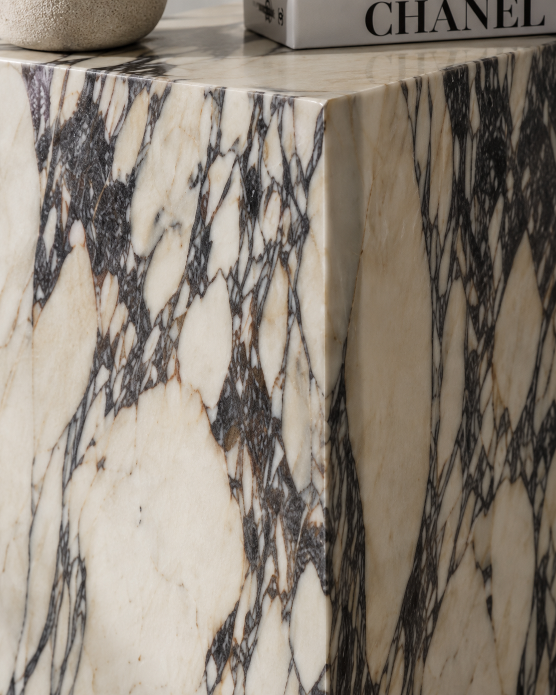 Material detail of VIOLA natural Calacatta Viola marble pedestal by DEKATO LIVING highlighting cream stone and expressive violet-dark veining