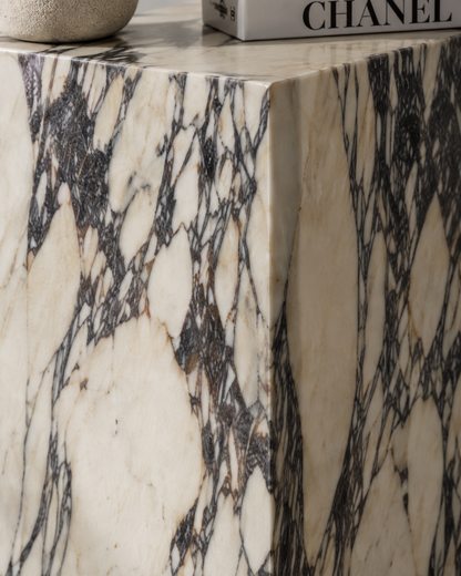 Material detail of VIOLA natural Calacatta Viola marble pedestal by DEKATO LIVING highlighting cream stone and expressive violet-dark veining